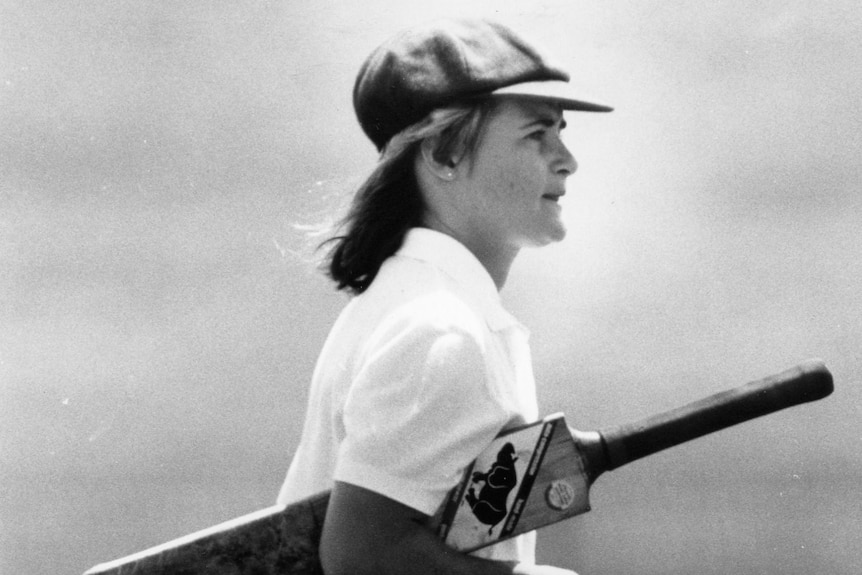 Lindsay Reeler walks with a cricket bat under her arm.