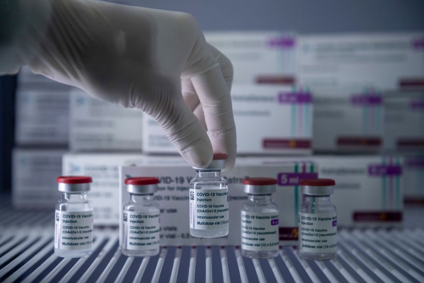 A healthcare worker holds the COVID-19 AstraZeneca vaccine.