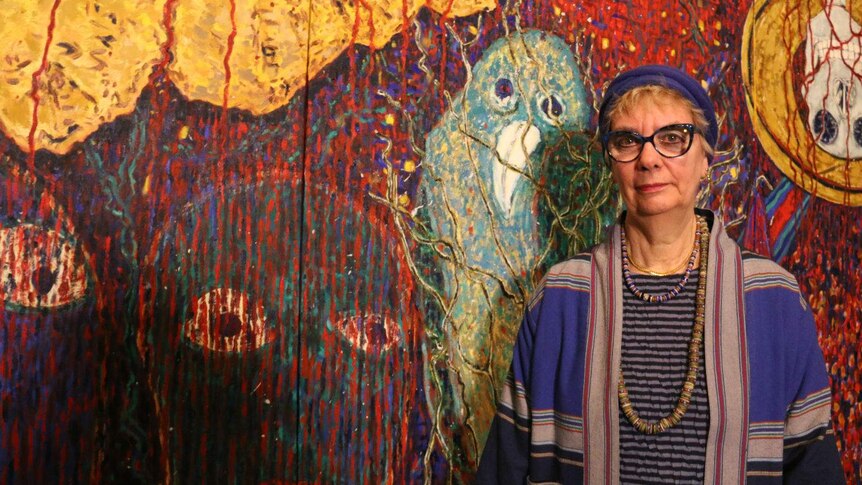 Artist Suzanne Archer in front of a painting