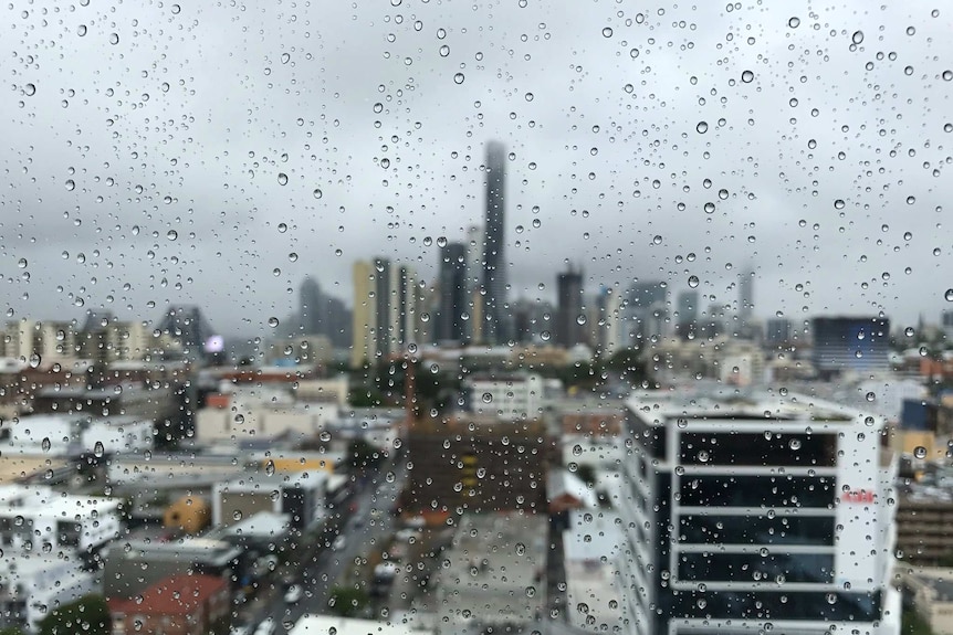 Raindrops on a window looking out towards Brisbane