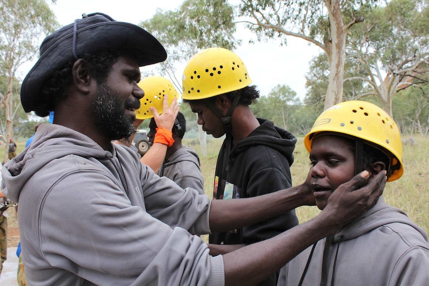 A teenager is readied for abseiling at a NT Corrections boot camp by Ron Poantimilui.