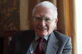 James Lovelock smiles at the camera while wearing a suit and tie.