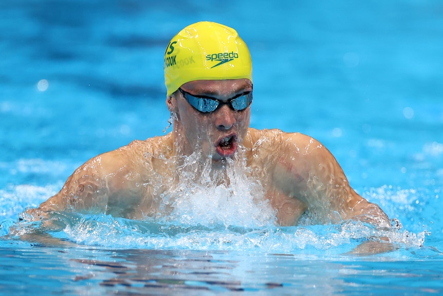 An Australian male swimmer competes in a breaststroke event at the Tokyo Olympics.