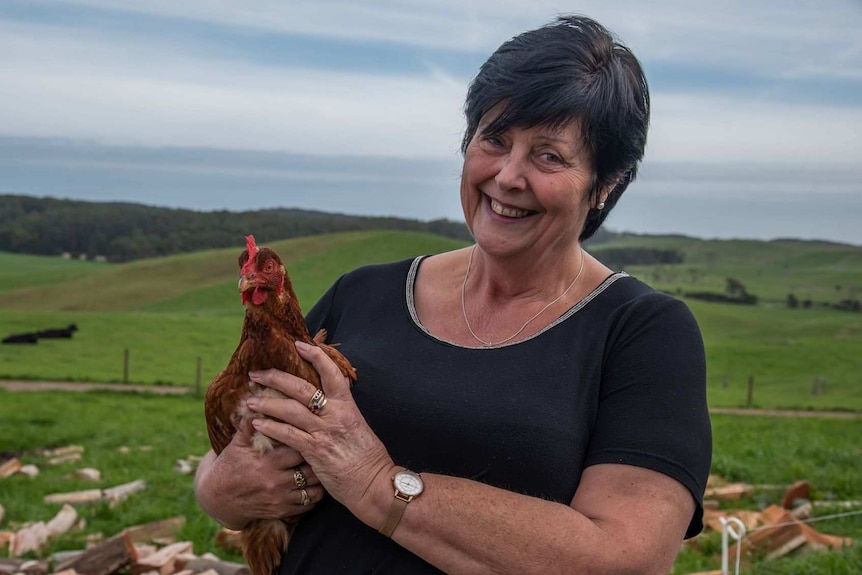 woman holding a chicken