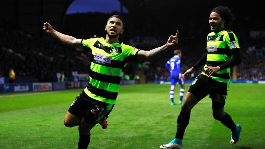 Huddersfield Town's Nahki Wells celebrates scoring their first goal with Isaiah Brown
