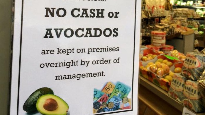 A sign reads no cash or avocados kept on premises