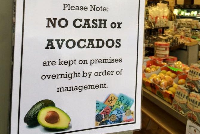 A sign reads no cash or avocados kept on premises