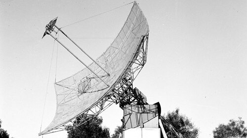 A black and white photograph of the 'Paraboloid' at Potts Hill, a convex wire dish