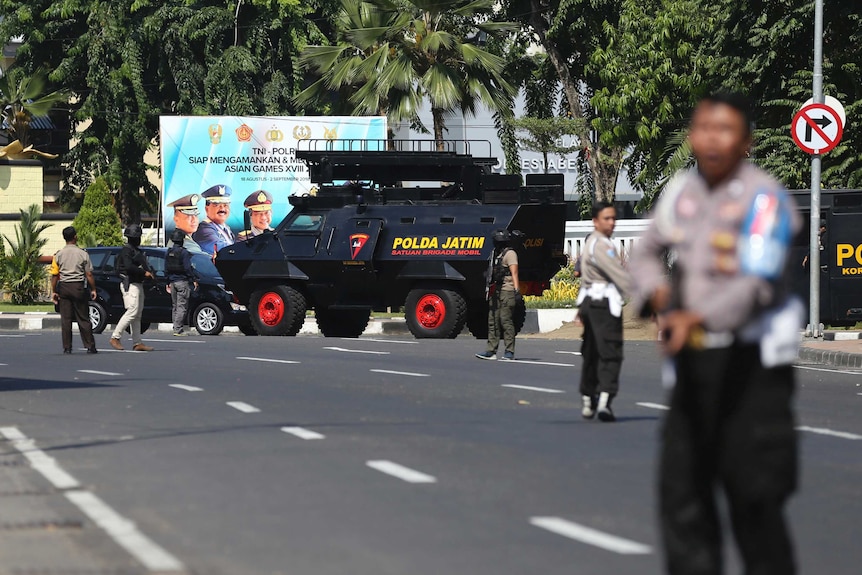 Police block road after suicide bombing in Surabaya