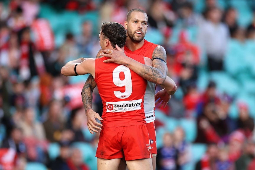 Lance Franklin and Will Hayward hug each other