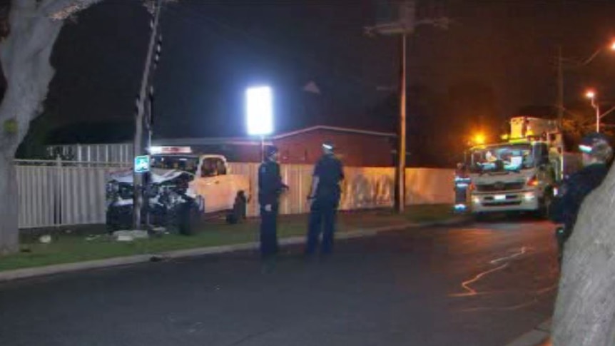 Police assess the damage to a Toyota Hilux ute.