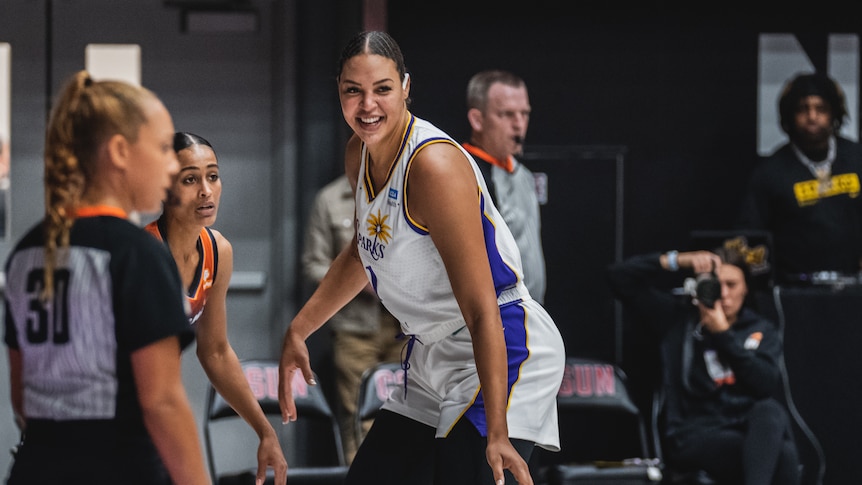 Australian basketballer Liz Cambage smiles as she looks downcourt during a preseason game in the WNBA.