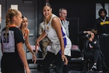 Australian basketballer Liz Cambage smiles as she looks downcourt during a preseason game in the WNBA.