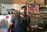 Andrea Bonotto stands behind the bar of Lismore cafe Dirty Wilson.