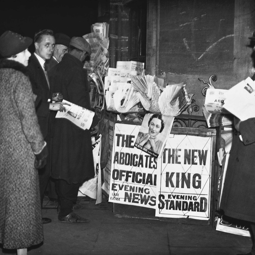 People surround a newspaper stand to read the news of King Edward VIII's abdication.
