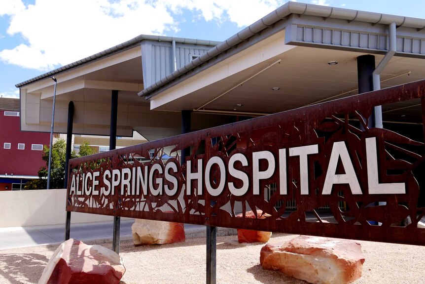 A modern-looking building with a latticed sign out the front that reads "Alice Springs Hospital".