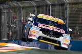 Shane van Gisbergen's Supercar is on its side two wheels doing over a corner