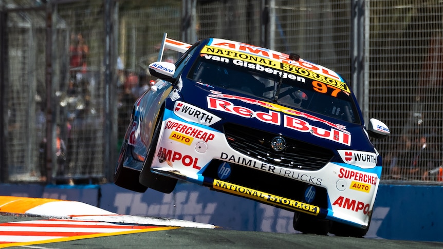 Shane van Gisbergen's Supercar is on its side two wheels doing over a corner