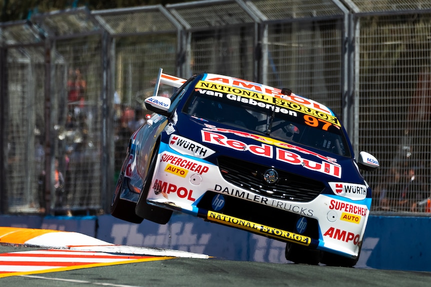 Shane van Gisbergen's Supercar is on its side two wheels doing over a corner