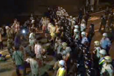Protesters beat drums and chant outside an nuclear reactor in Oi