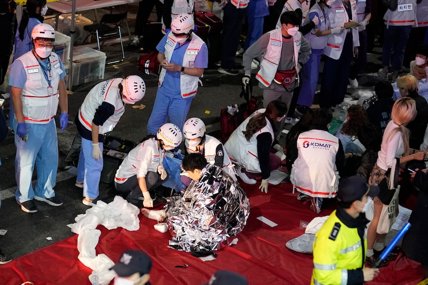 Rescue workers treat injured people on the street in Seoul.