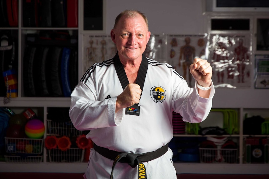 Ronald Bergan stands in a taekwondo pose.