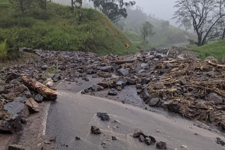 Rocks and water over a road.