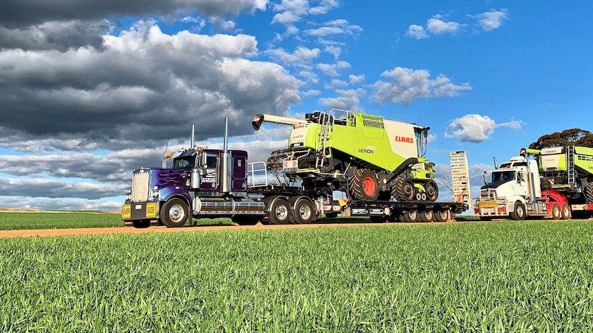 a truck carrying a harvester