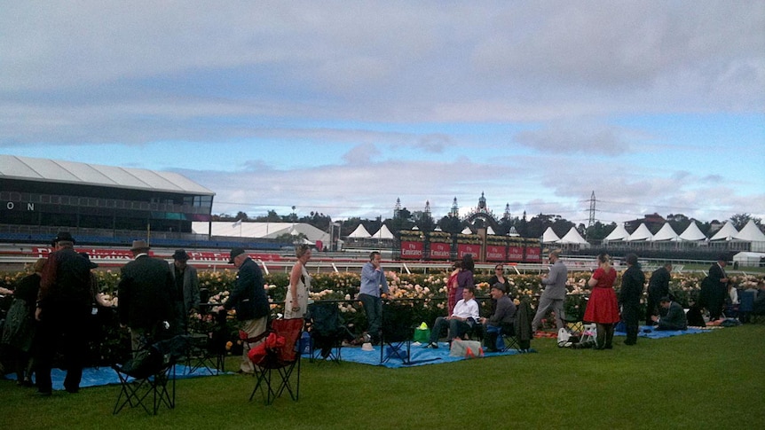 Some of the crowd at Flemington race course stake their claim early on Melbourne Cup day.