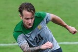 The Socceroos' Adam Taggart fights for the ball against Brazilian side Parana Clube in Vitoria