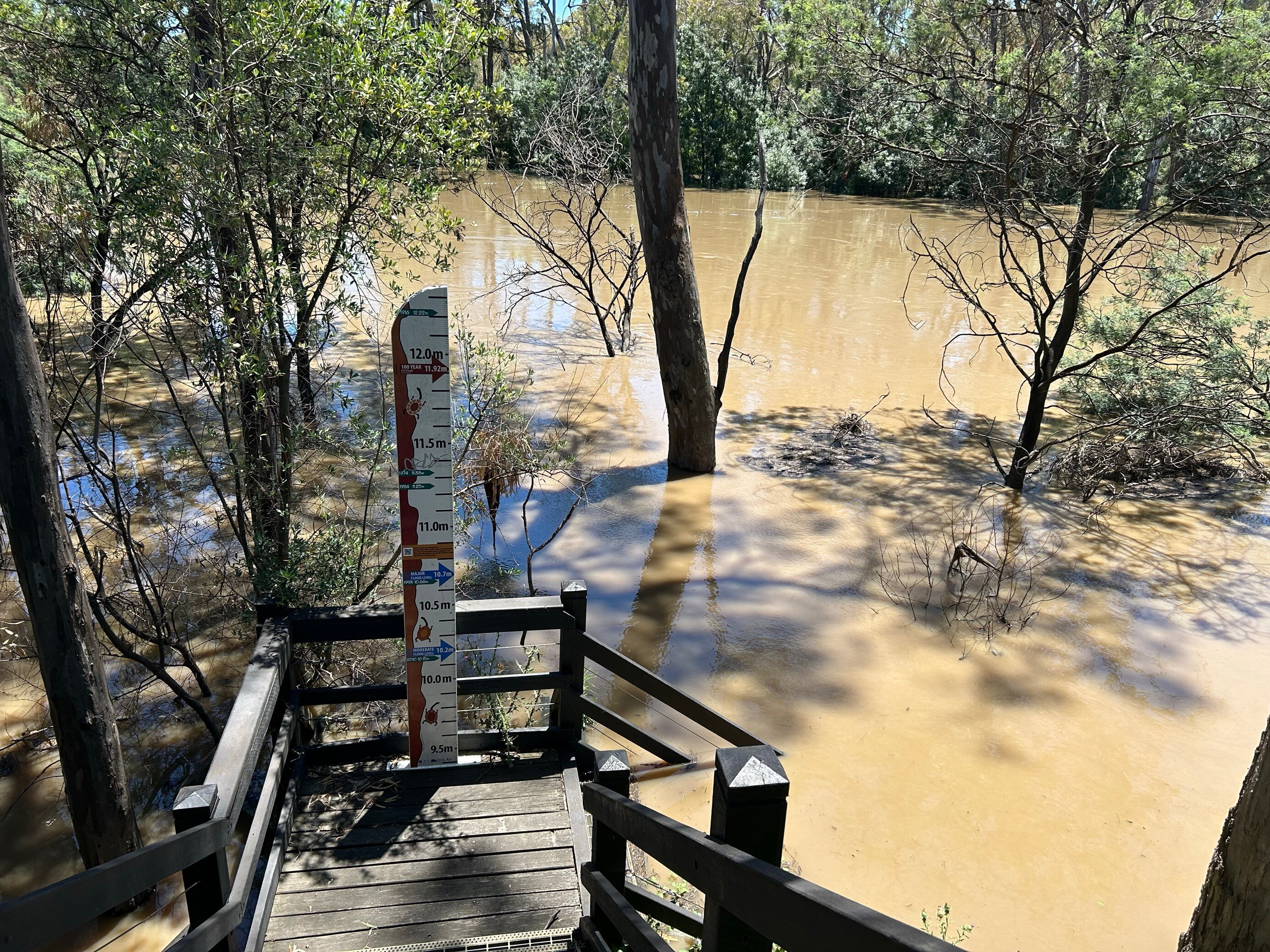 a flood indicator next to a flooded creek