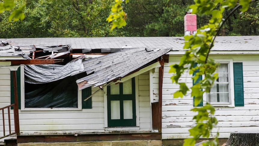 The roof of a house is seen affected by winds from Hurricane Florence.