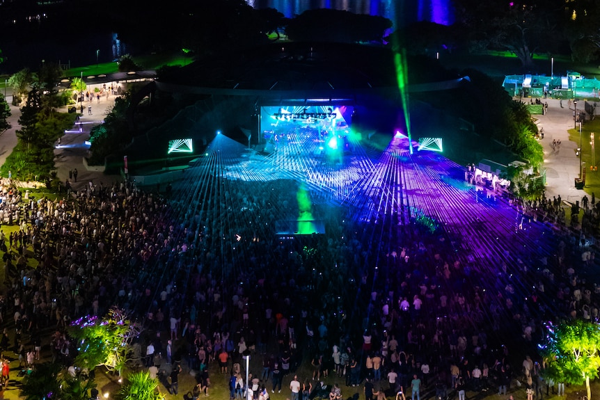 large outdoor stage at night with crowd