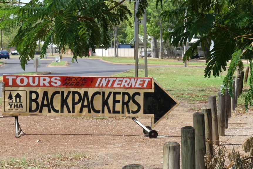 Sign advertising backpacker accommodation next to road