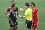 Issey Nakajima-Farran of the Roar receives a yellow card during the round 14 A-League match against the Brisbane Roar at Hindmarsh Stadium on January 7, 2012