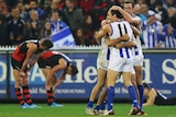 The Kangaroos' Luke McDonald (L) Michael Firrito (C) and Todd Goldstein after the win over Essendon.