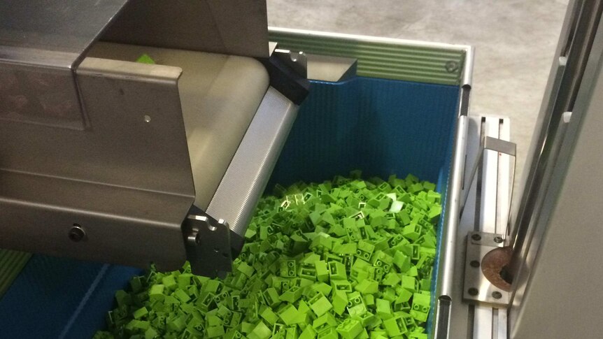 A freshly made box of green Lego.