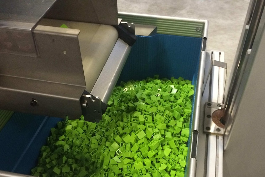 A freshly made box of green Lego.