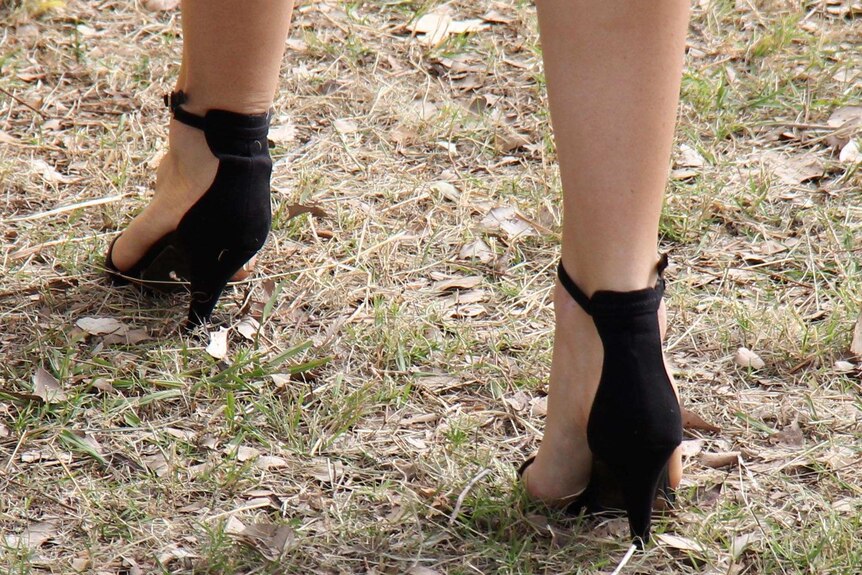 A woman's high heels dig into the ground at the Burrandowan Picnic Races.