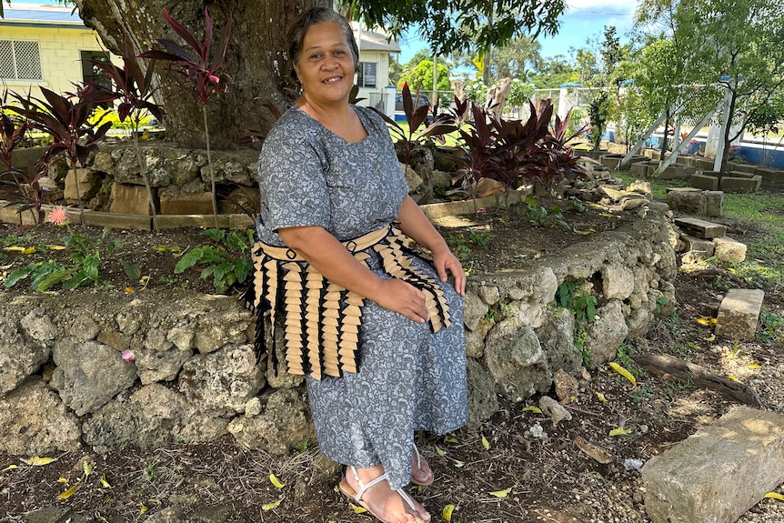 Tongan woman Sela Latailakepa sits down in the garden of her home in Nuku'alofa. 