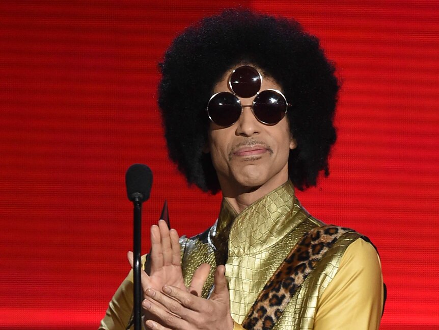 Prince speaking onstage during the 2015 American Music Awards