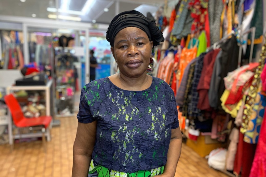 Woman stands in her shop in an inner suburb of Melbourne.