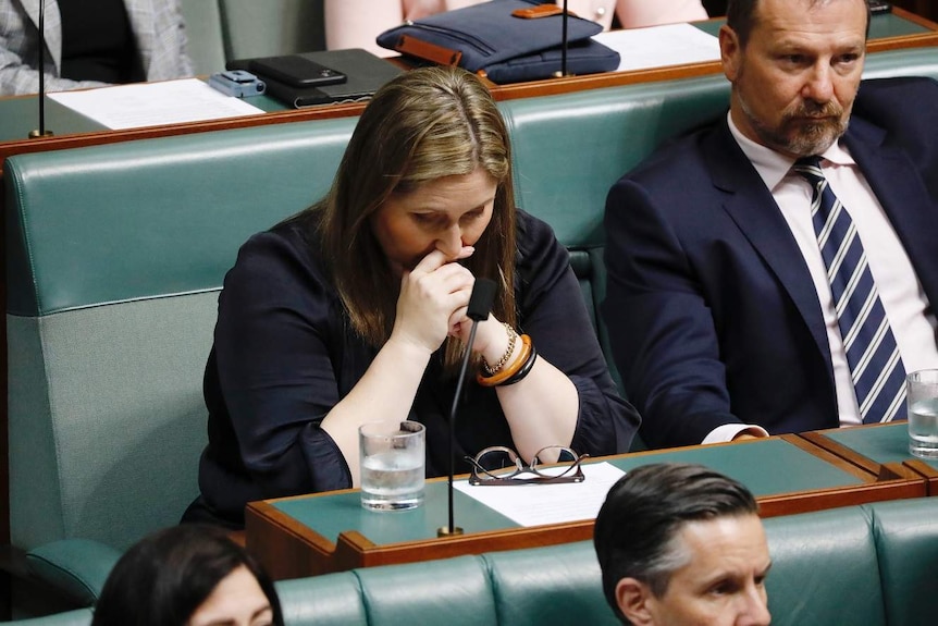 Labor MP Emma McBride sits with her head in her hands