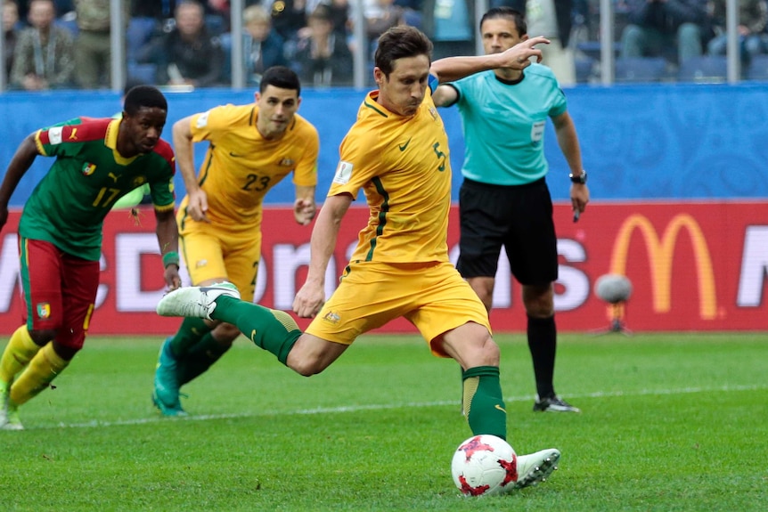 Australia's Mark Milligan takes a penalty kick during the Confederations Cup, Group B soccer match against Cameroon.