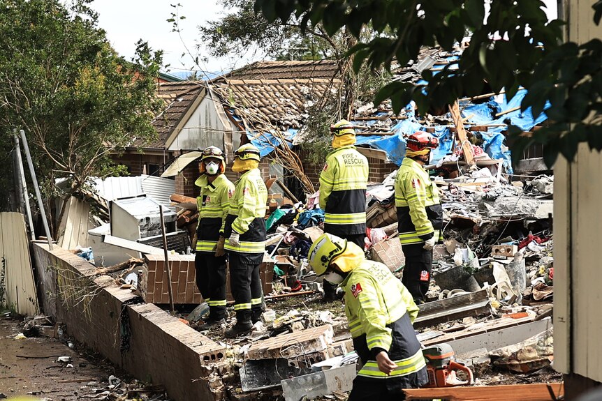 Fire Rescue personnel at the scene following the explosion of a townhouse in Whalan