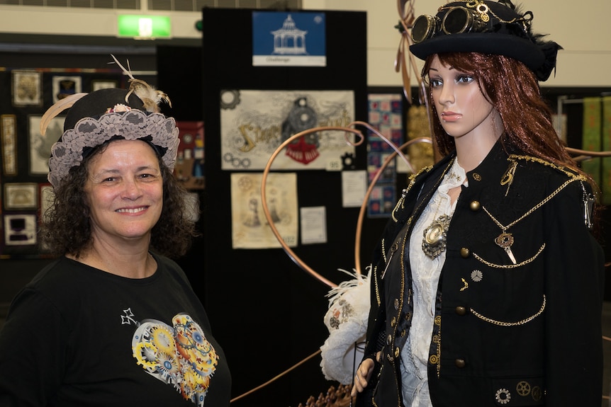 Anne Maree Serrano stands next to a creation by Glenys Elliot.