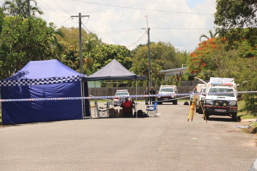 Police cars and tents set up on a Cairns street.