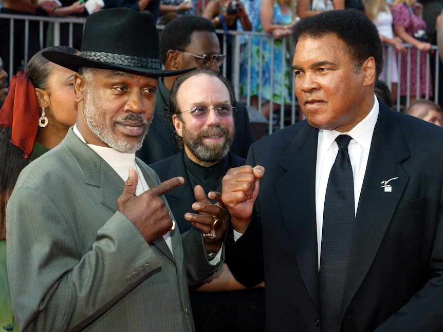 Joe Frazier poses with Muhammad Ali
