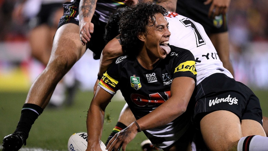 Jarome Luai sticks his tongue out as he celebrates a try for the Panthers.