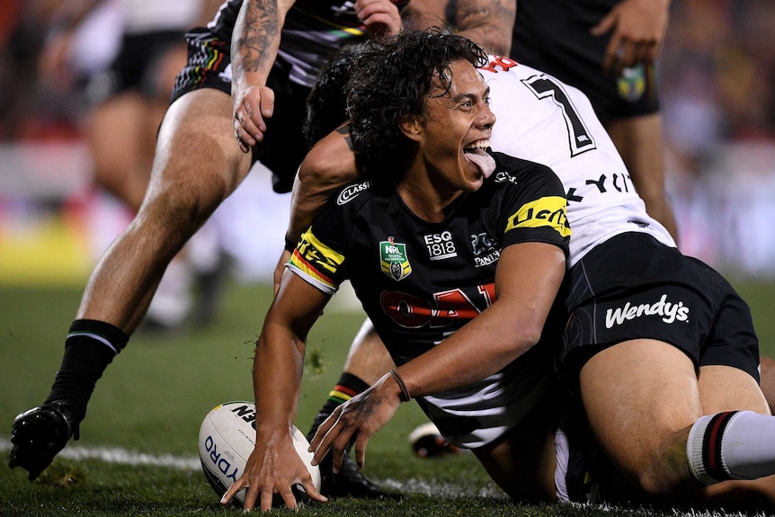 Jarome Luai sticks his tongue out as he celebrates a try for the Panthers against the Warriors.